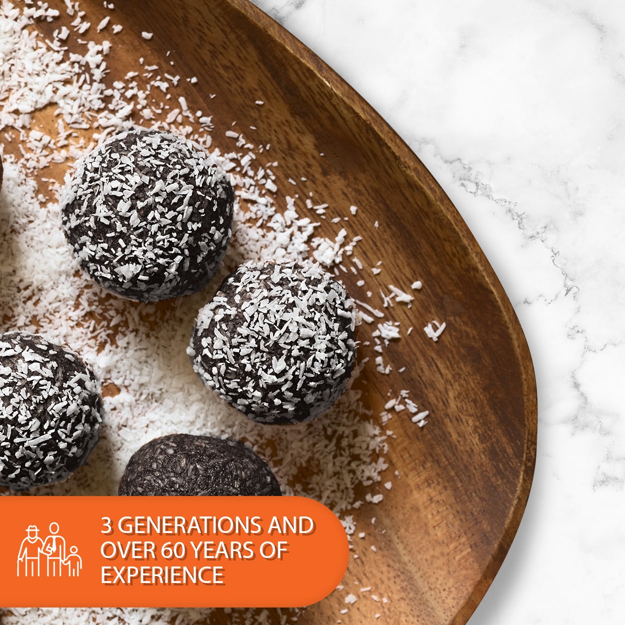 Chocolate rum balls coated in shredded coconut on a rustic wooden serving board with a marble background. Low-carb, sugar-free, keto-friendly chocolate truffles.