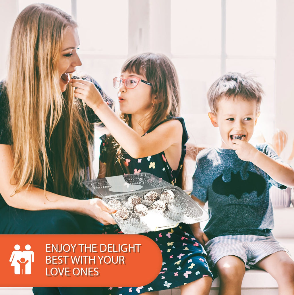 Happy family sharing sugar-free keto rum balls together, with a woman feeding a young girl while a smiling boy enjoys a chocolate treat, highlighting wholesome moments, low-carb indulgence, and family-friendly snacking.