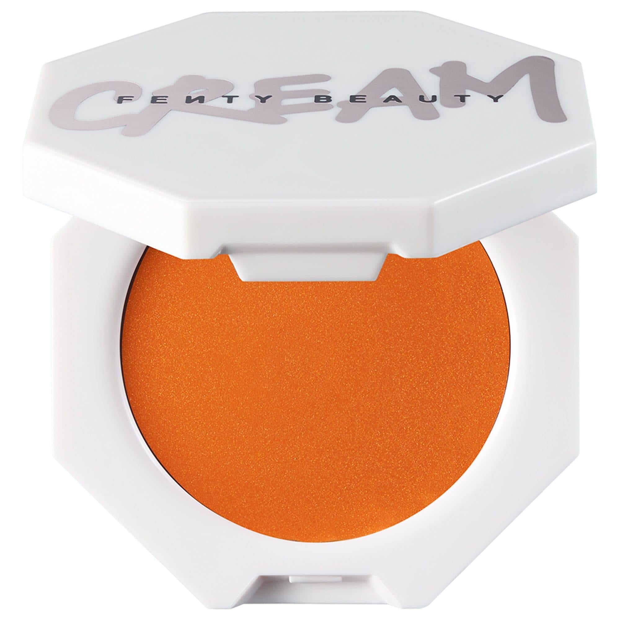 Fenty Beauty Cheeks Out Freestyle Cream Blush in a white octagonal compact with the Fenty Beauty logo on the lid, shown open to reveal vibrant orange cream blush with a smooth satin finish.