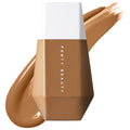 Fenty Beauty liquid foundation bottle in a warm medium tan shade, shown with a white cap and a diagonal swipe of the foundation cream on a white background. Fenty Beauty Eaze Drop: Blurring Skin Tint Foundation - Light Coverage, Natural Finish, Vegan & Cruelty-Free, Buildable Hydrating Skin Tint