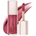 Fenty Beauty Gloss Bomb Universal Lip Luminizer lip gloss with shimmer finish, doe-foot applicator, and matching swatch on a white background.