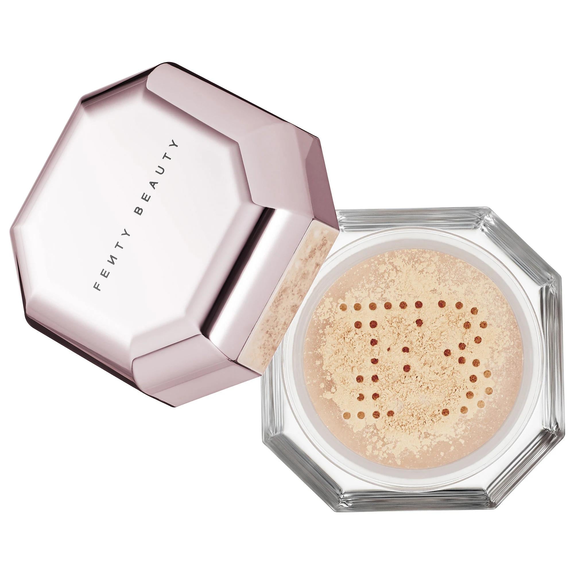 Fenty Beauty Pro Filt'r Instant Retouch Setting Powder compact with open hexagonal lid, translucent loose powder, and signature FB sifter on a white background.