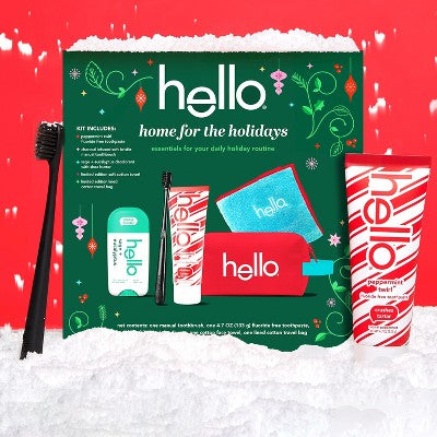 hello Home for the Holidays 5-piece travel toiletry gift set with peppermint toothpaste, deodorant, bamboo toothbrush and reusable zippered toiletry bag, holiday oral care and personal hygiene essentials.