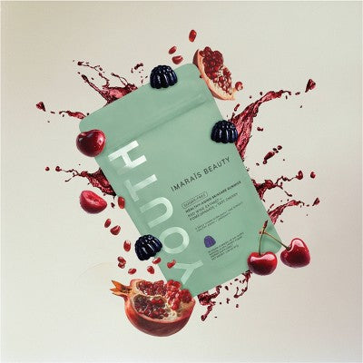 Sheet mask with 'Youth' text surrounded by fruits on a beige background