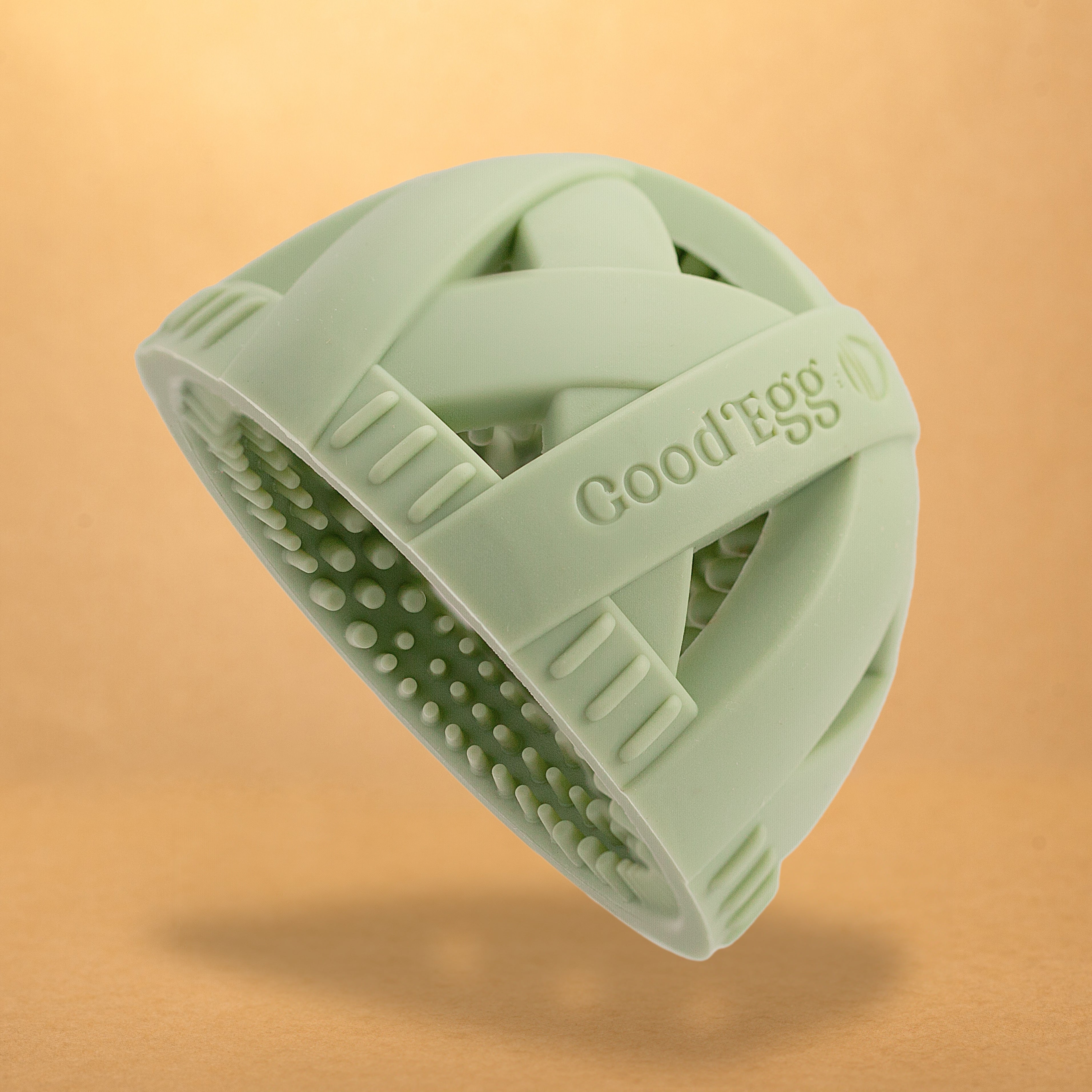 Original GoodEgg Brush™ in soft sage green featuring a seamless food-grade silicone design, ergonomic cross-strap grip, and 650+ flexible scrubbing nubs for gently cleaning fresh chicken, duck, goose, and quail eggs.