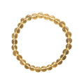 Gold beaded bracelet on a white background. Citrine Bracelet 6 mm Faceted Round Beads – Abundance and Cheer