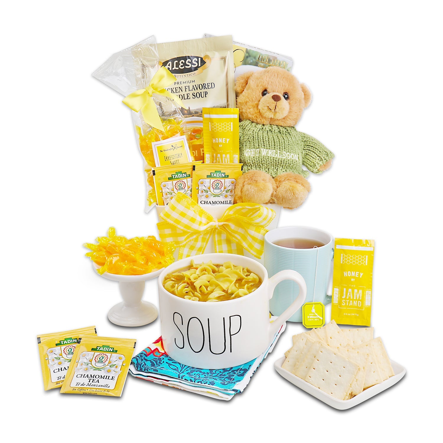 Gourmet gift basket with soup, tea, cookies, and a teddy bear on a white background. Hugs & Well Wishes Gift Basket: Alessi Premium Chicken Flavored Noodle Soup, Artisan Olive Oil & Sea Salt Crackers, Butterscotch Candy, Chamomile Tea, 2 Honey Sticks, Plush Teddy Bear with “Get Well Soon” Sweater