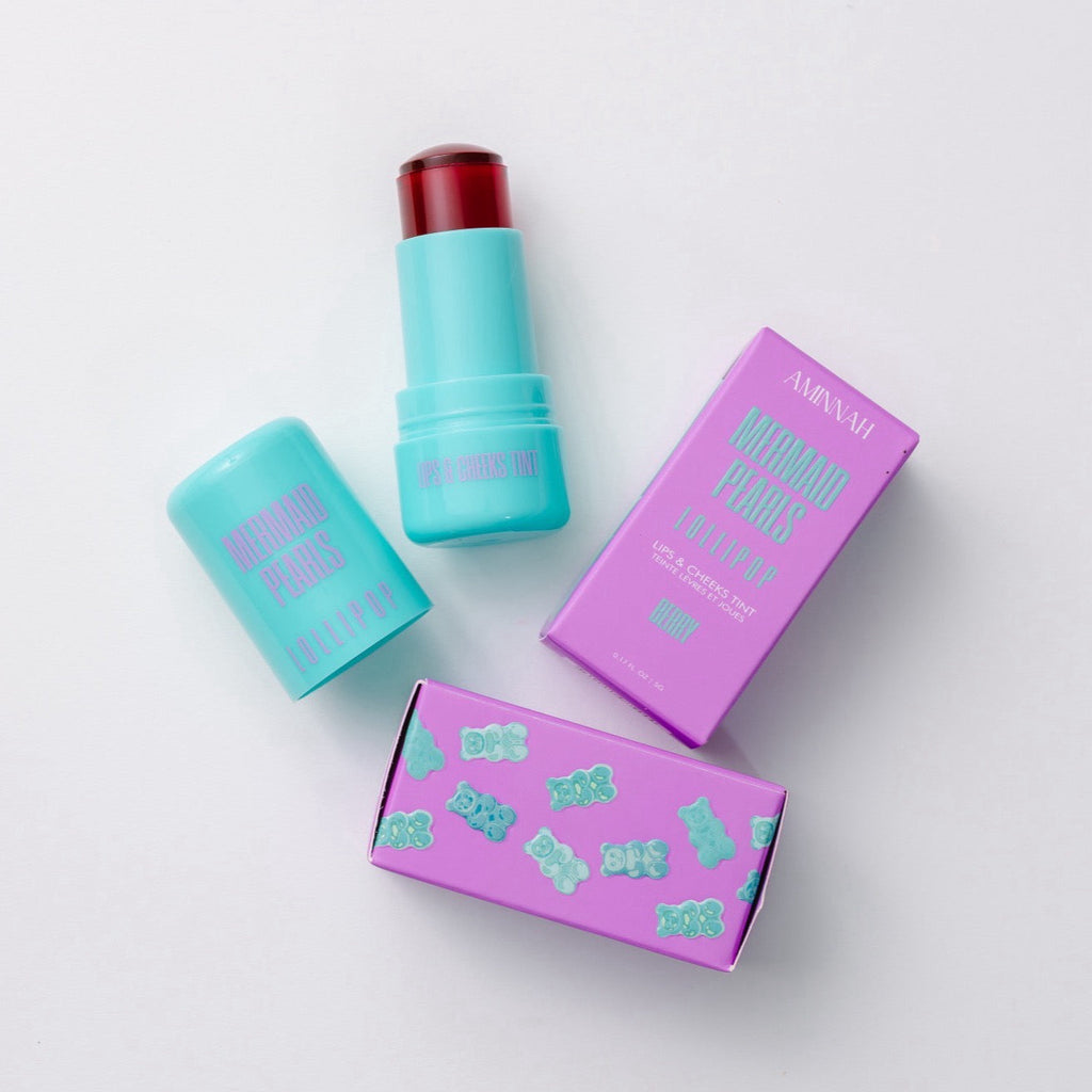 Mermaid Pearls LOLLIPOP Berry Lip & Cheek Tint with aqua twist-up tube, translucent berry jelly formula, and purple gummy bear packaging. Hydrating, buildable color for lips and cheeks. Vegan, cruelty-free, clean beauty makeup.