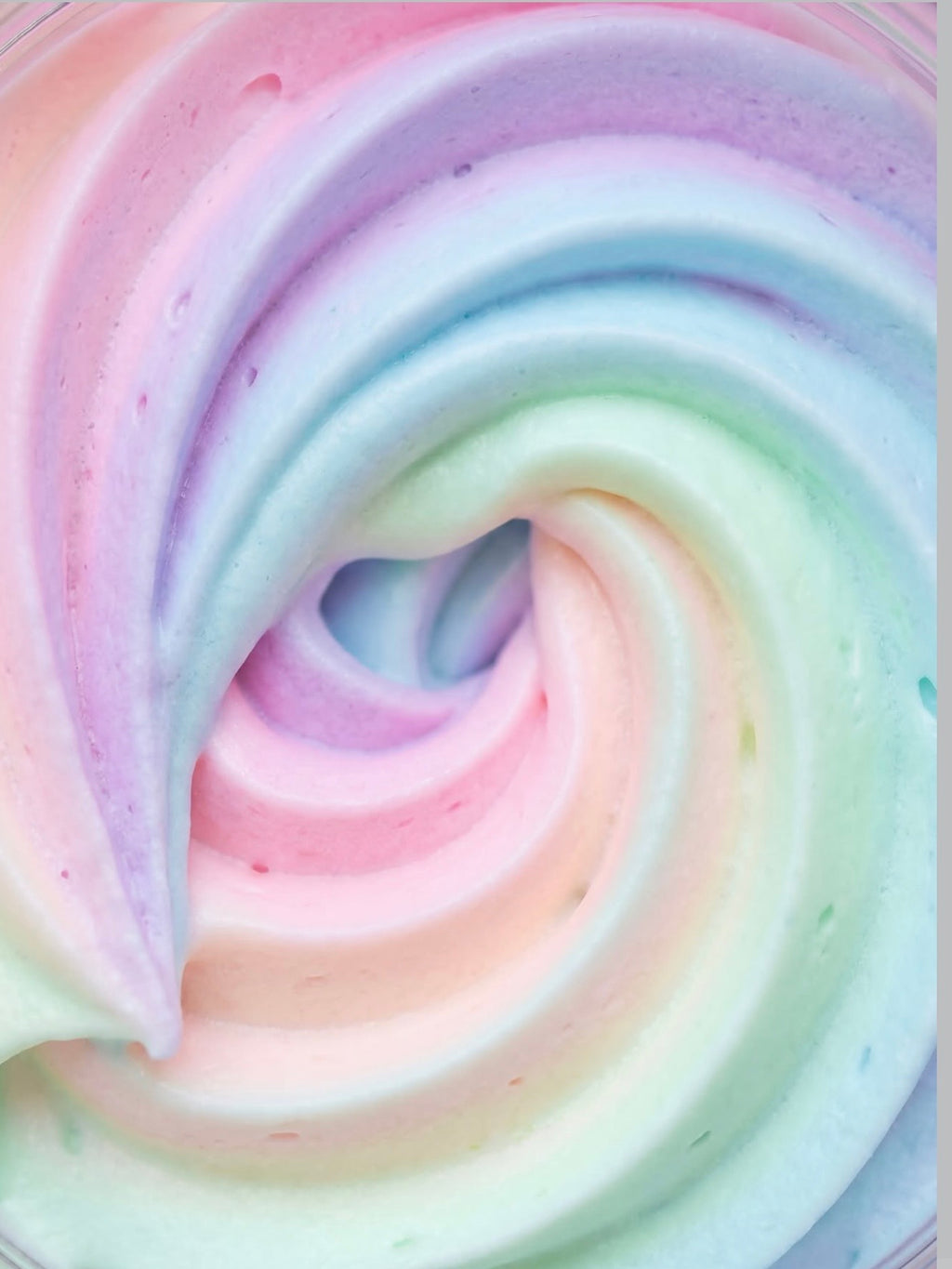 Pastel rainbow whipped body butter swirl with soft pink, lavender, mint, blue, and cream colors in a luxurious skincare texture. Clean beauty by AMINNAH, crafted with natural ingredients and vegan-friendly formulas. Cruelty-free, paraben-free, gluten-free, and packaged in recyclable packaging by a female-owned brand for a nourishing self-care experience.