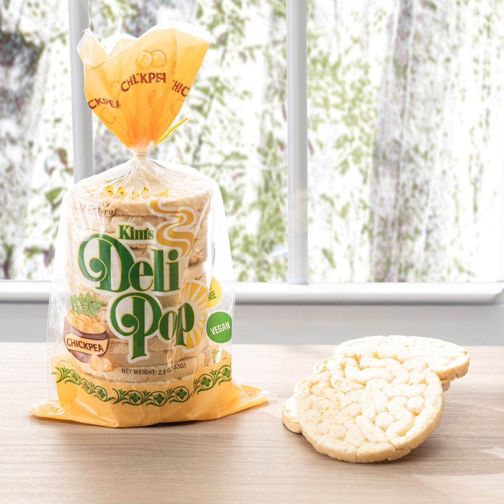 Kimi's Deli Pop package with crackers on a table near a window