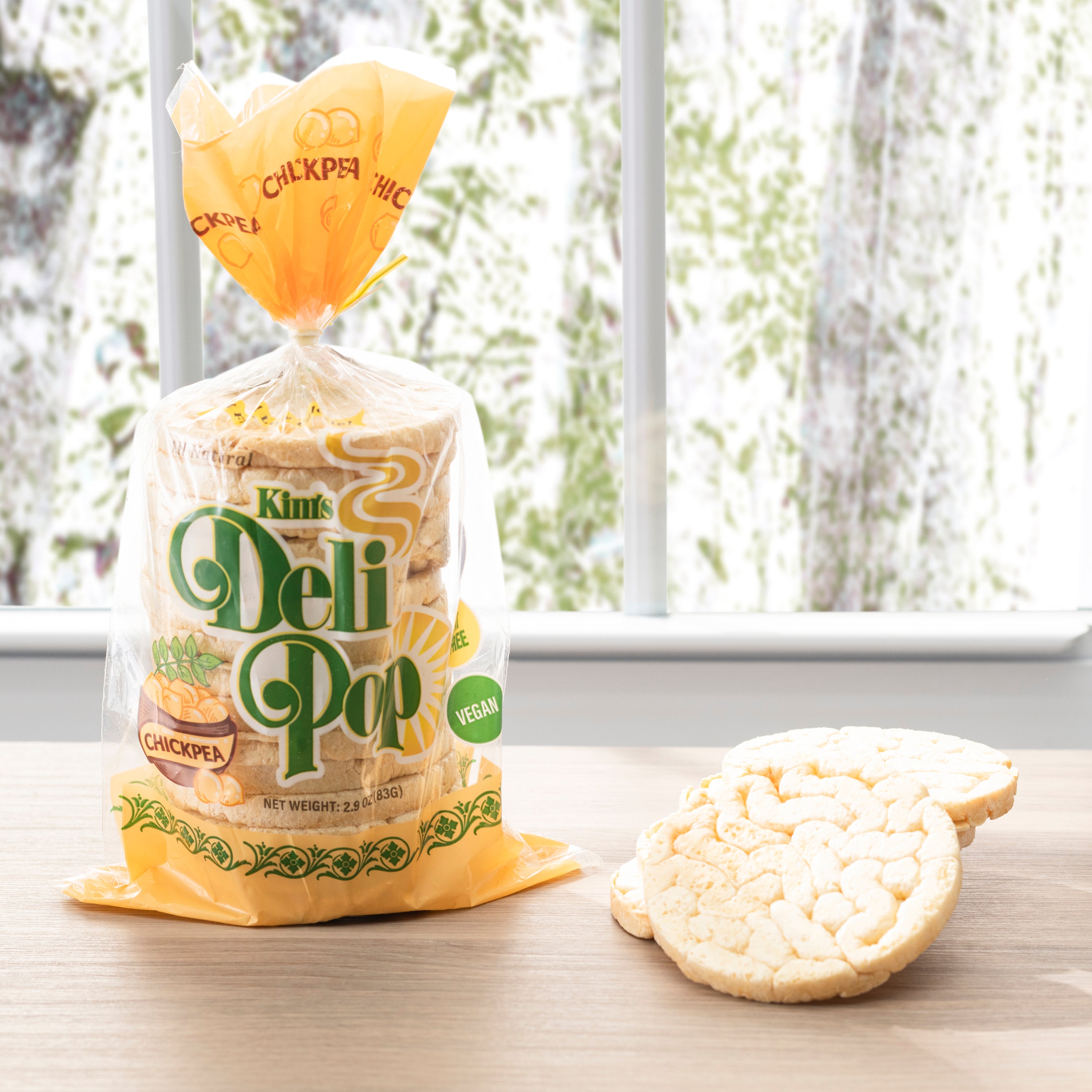Kimi's Deli Pop package with crackers on a table near a window