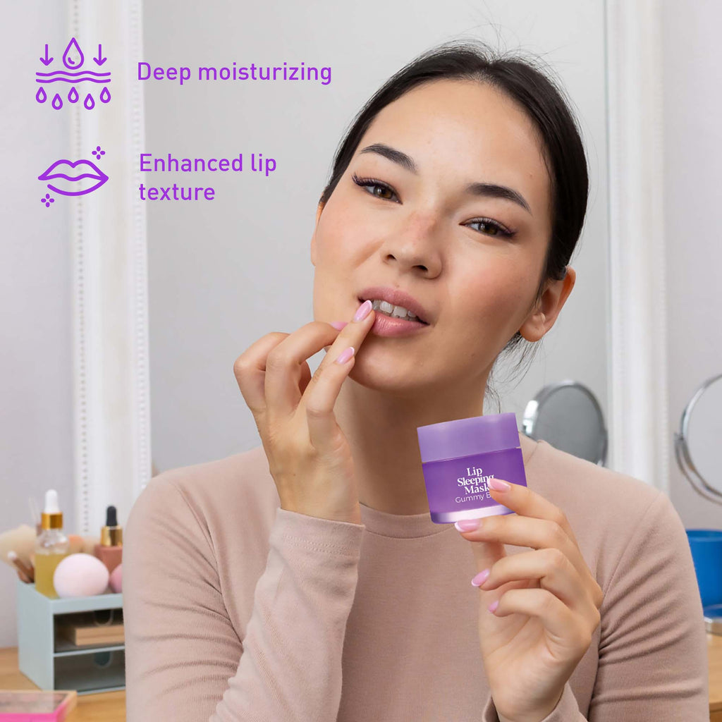 Hydrating Lip Sleeping Mask Collection Bundle featuring Cherry Blossom & Berries, Gummy Bear, and Fresh Mint. Model applying nourishing overnight lip mask while holding the product. Infused with moisturizing ingredients to help soften, smooth, and replenish dry lips for a healthy-looking, hydrated pout. Vegan, cruelty-free lip care set.