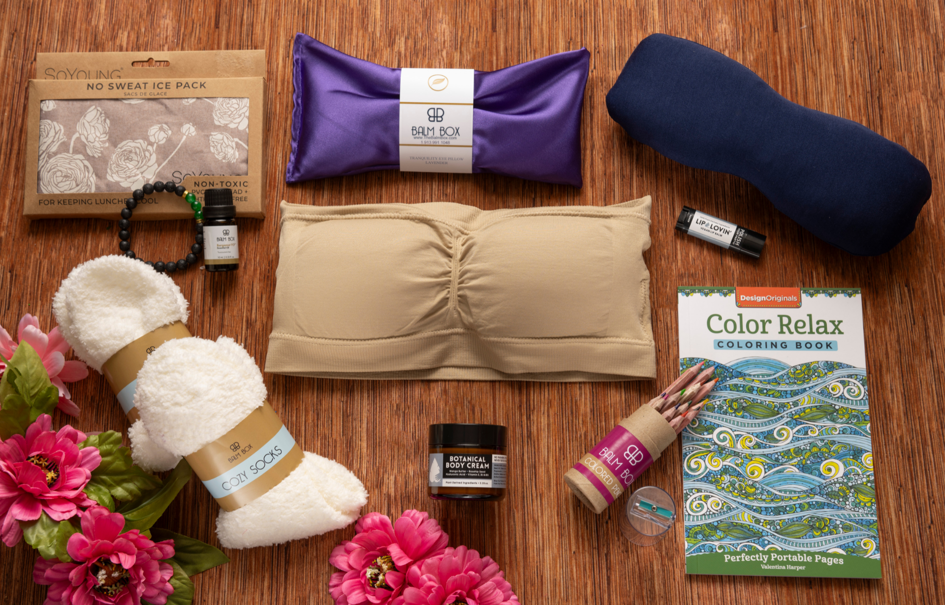 The Ideal Lumpectomy Care Package for Women, Breast Surgery Recovery Gift Set, Lumpectomy Recovery Care Package with Supportive Breast Care Bandeau, Reusable Cooling Ice Pack, Cozy Socks, Sleep Mask, Soothing Body Balm, Lip Care, Relaxing Coloring Book and Colored Pencils, Breast Cancer Support Gift, Post-Surgery Self-Care and Comfort Wellness Gift Set with Healing Essentials on Wooden Background with Flowers