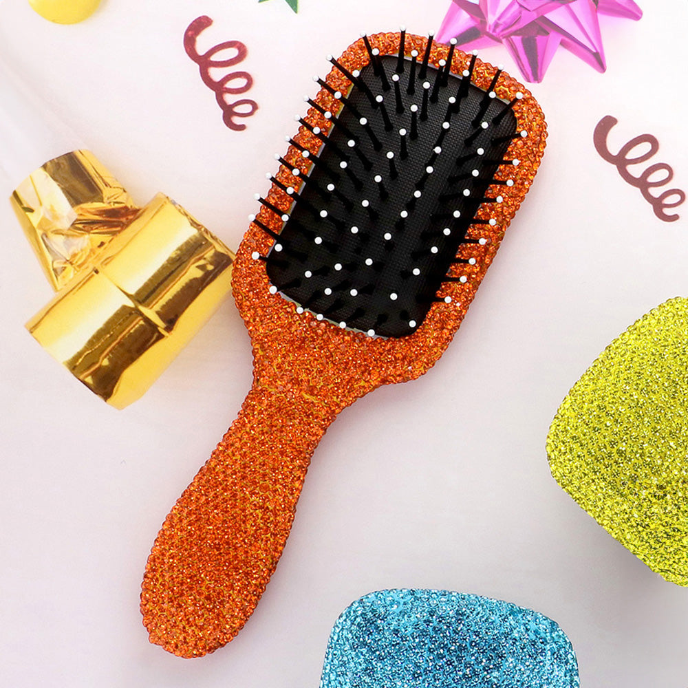 Orange rhinestone pave paddle hair brush with sparkling crystal handle, black detangling bristles and white tips, glamorous styling brush for women and girls