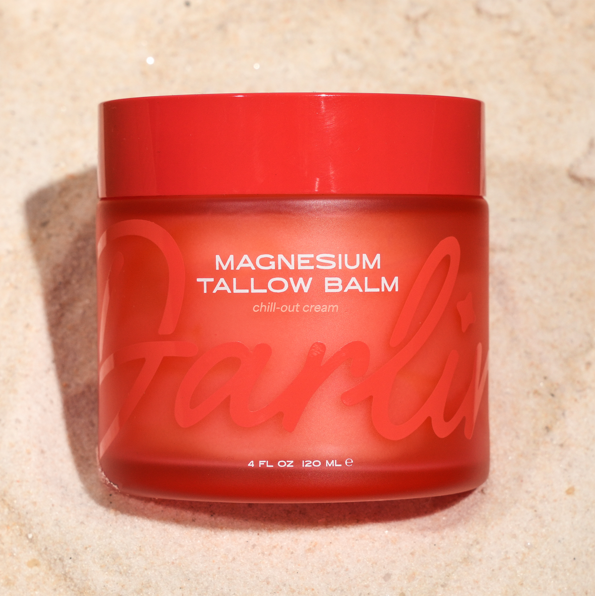 Magnesium Tallow Balm 4 oz in red jar on soft sand, natural grass-fed beef tallow and magnesium body balm for deep hydration, dry skin relief, muscle relaxation, nighttime moisturizer, non-toxic skincare, clean beauty, sensitive skin balm, nourishing whipped tallow cream, skin barrier support, wellness self-care product.