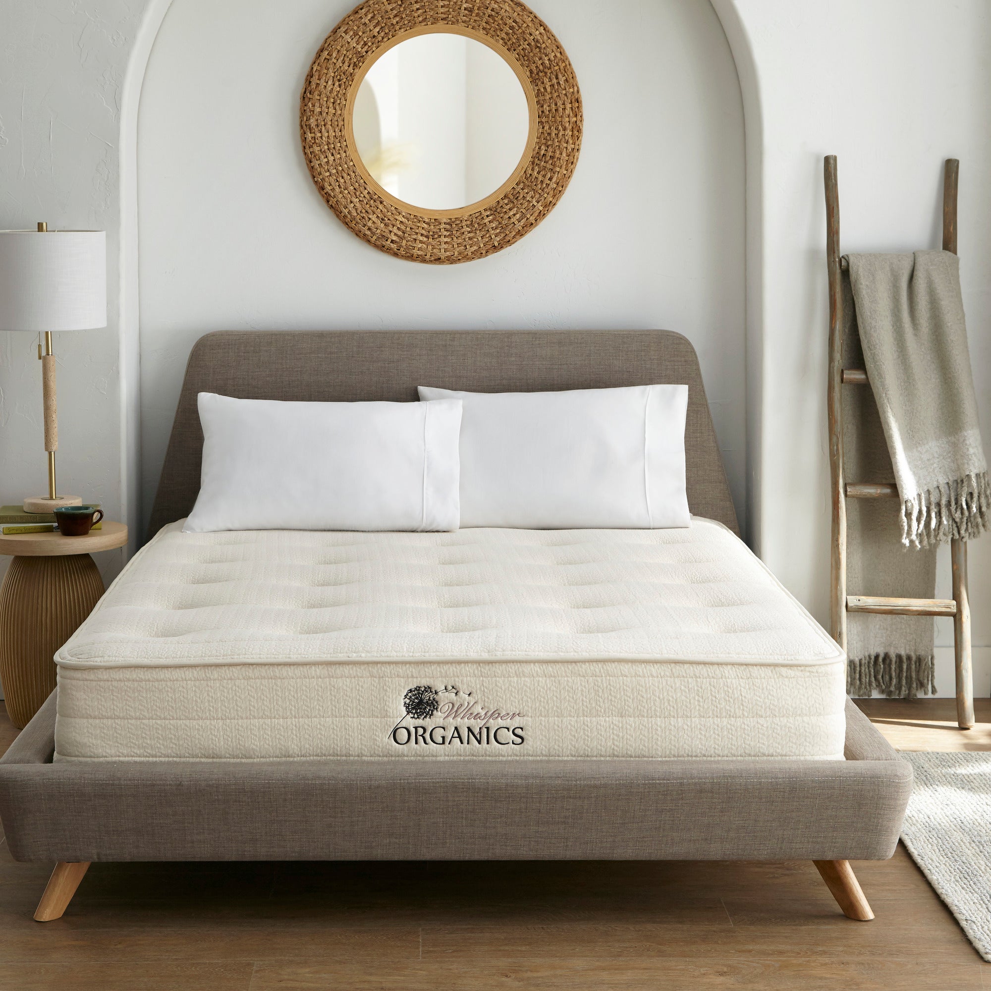 Mattress on a bed in a bedroom with 'Whitney Organics' branding. 100% GOTS & GOLS-Certified organic cotton, wool and latex, 10" profile: 2" organic Dunlop latex + 7-zone pocketed coils, Medium feel for that “just right” balance of comfort + support, Breathable organic wool & cotton cover for airflow and temperature regulation, Lumbar support with zoned coil design, Suitable for an adjustable base & Made with sustainable, renewable materials, Made in the USA