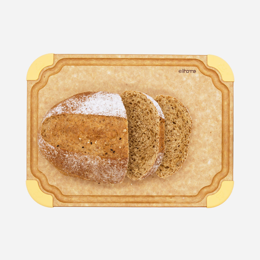 Freshly sliced artisan bread loaf displayed on a durable non-slip color-coded cutting board, showcasing a medium-sized kitchen prep board for safe food preparation and everyday cooking.