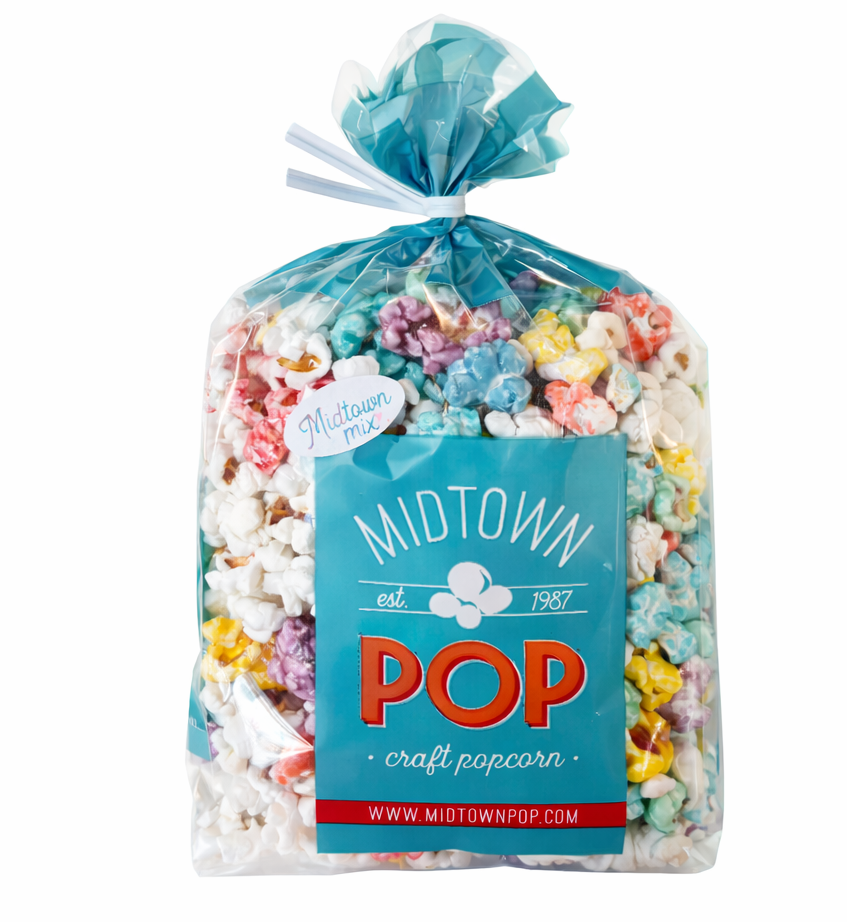 Bag of Midtown Pop craft popcorn with colorful kernels on a white background