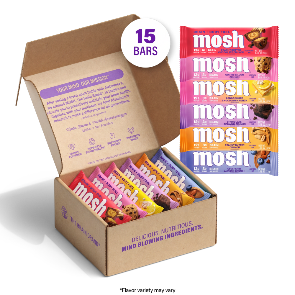 An open cardboard box of Mosh protein bars with several colorful individual packet bars displayed beside it on a white background. A white circular badge reads '15 BARS', and the box interior shows purple branding and flavor labels. Chocolate Brownie Crunch 3x
Peanut Butter Crunch 3x
Peanut Butter Chocolate Crunch 3x
Cookie Dough Crunch 1x
Blueberry Almond Crunch 2x
Lemon White Chocolate Crunch 3x