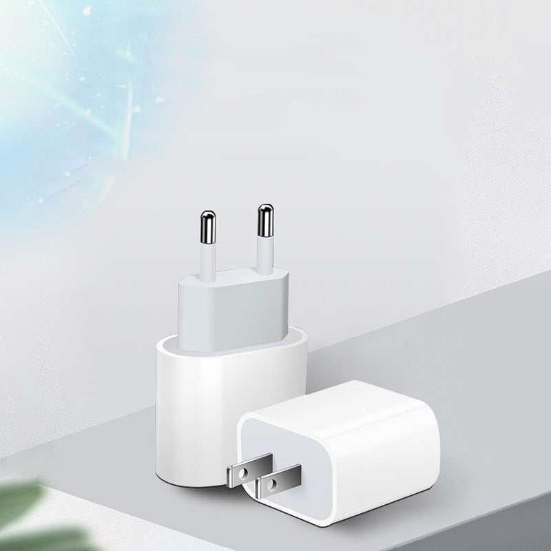 White USB-C wall charging power adapter on a light gray surface with a soft blue gradient background. Mobile Phone Charger Direct Charge PD20W - USB-C Wall Power Adapter