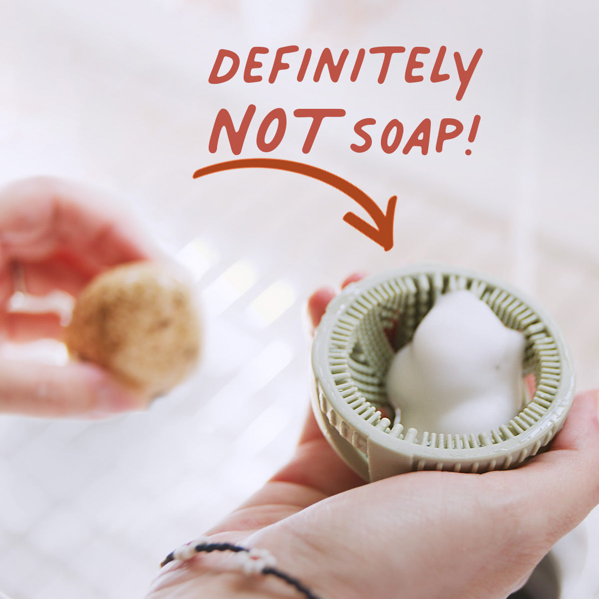 GoodEgg Wash foaming egg cleaning brush demonstrating that the rich cleaning foam is powered by natural enzymes—not soap—for safely cleaning fresh chicken, duck, and other poultry eggs without penetrating the eggshell. Image includes the text "Definitely Not Soap!" pointing to the foaming brush.