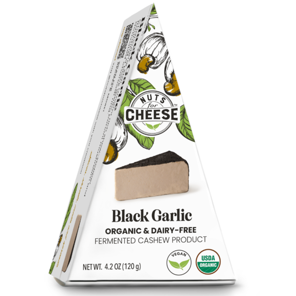 Organic dairy-free black garlic cashew cheese wedge in triangular retail packaging with USDA Organic and vegan certification on a white background.