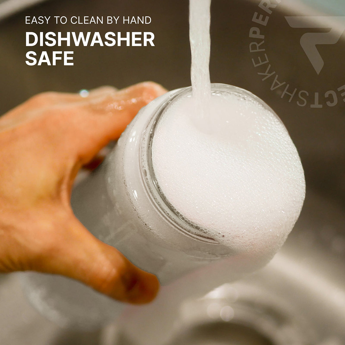 A hand holds a clear glass jar under running water in a sink, with white foam overflowing from the top. Text on the image reads 'EASY TO CLEAN BY HAND DISHWASHER SAFE'.