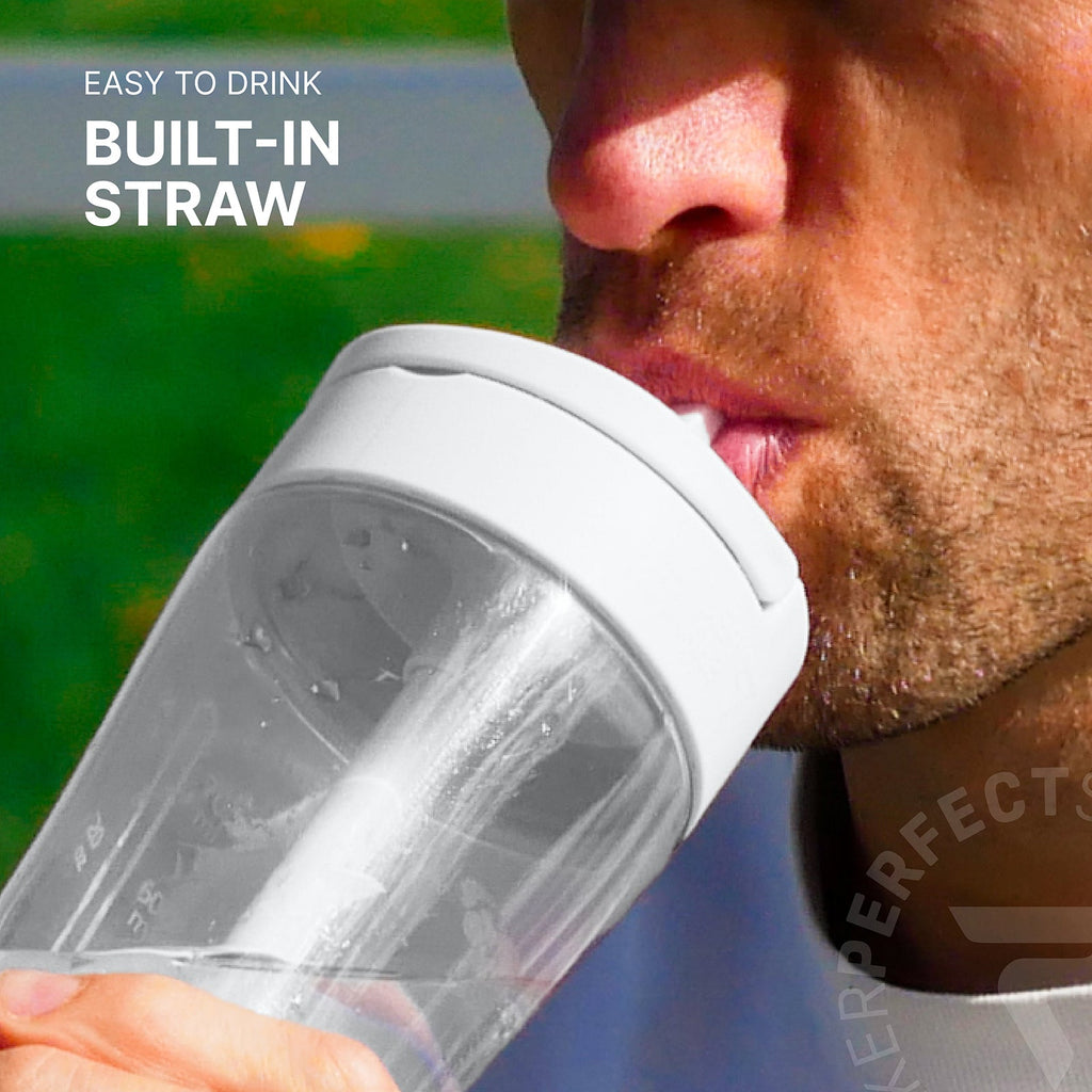 A close-up lifestyle shot of a man drinking from a clear plastic water bottle with a white built-in straw lid. The background is a blurred green outdoor setting, and white text on the top left reads 'EASY TO DRINK BUILT-IN STRAW'.