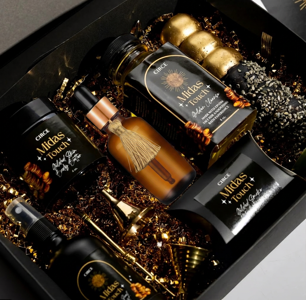 Circe Midas Touch Ritual Collection abundance skincare gift set with body oil, gold-infused cleanser, scrub and luxury self-care products in elegant black and gold packaging.