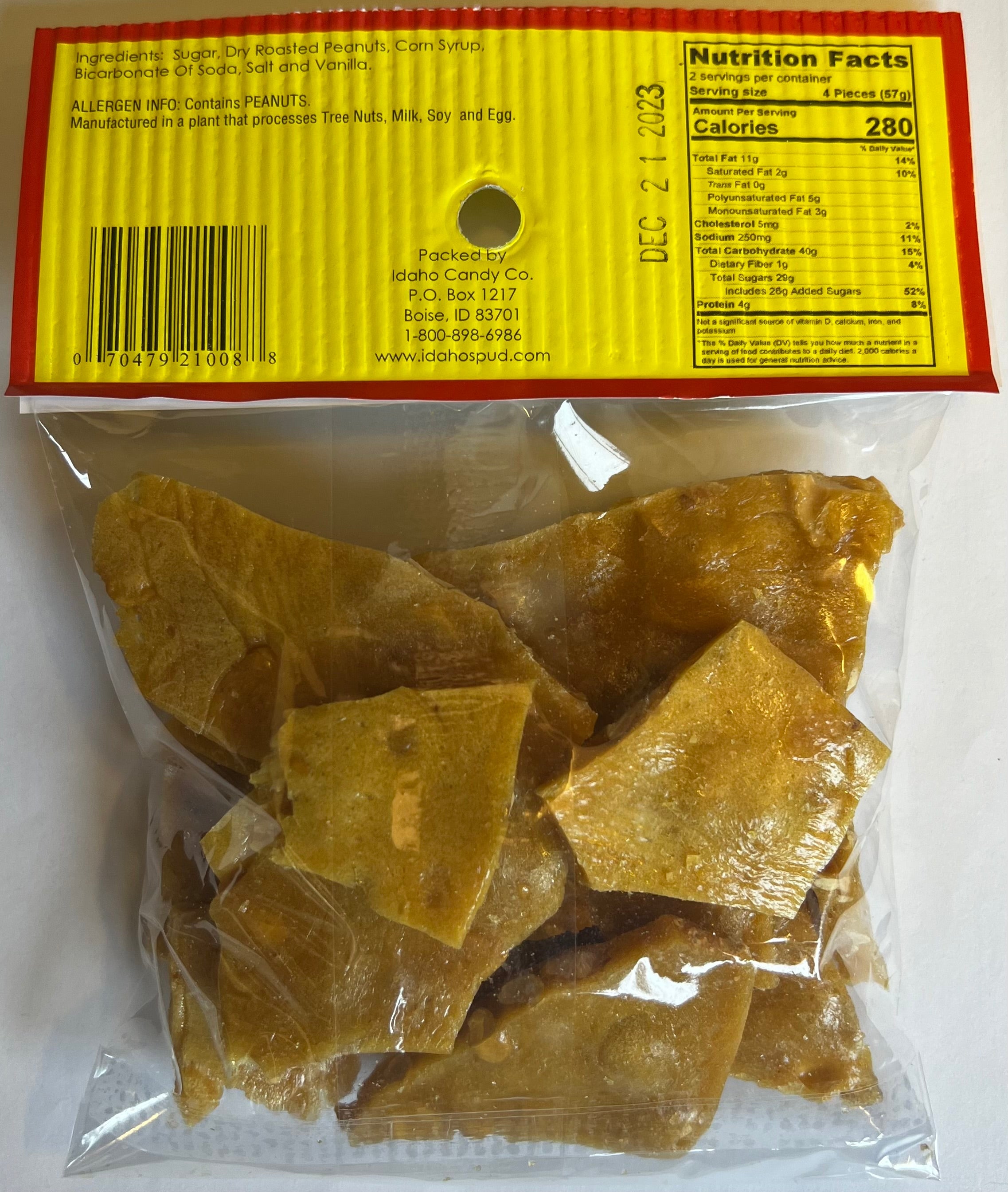 Idaho Spud Old Fashioned Peanut Brittle 4 oz bag back with roasted peanut candy, ingredients, nutrition facts, allergen info and UPC barcode
