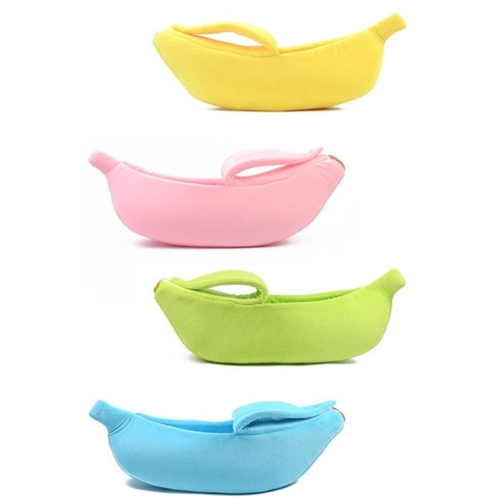 Colorful banana-shaped pet beds in yellow, pink, green, and blue displayed on a white background, showcasing soft, cozy sleeping beds for cats and small dogs.