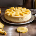 Cheesecake with pineapple slices on a wooden table