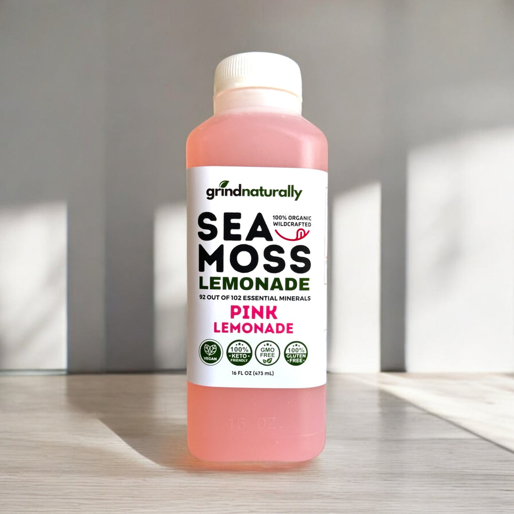 Bottle of Sea Moss Lemonade with a white label on a wooden surface. #1 Flavored Sea Moss Lemonade (16oz)