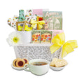 Tea gift basket with tea bags, cookies, and a cup of tea on a white background