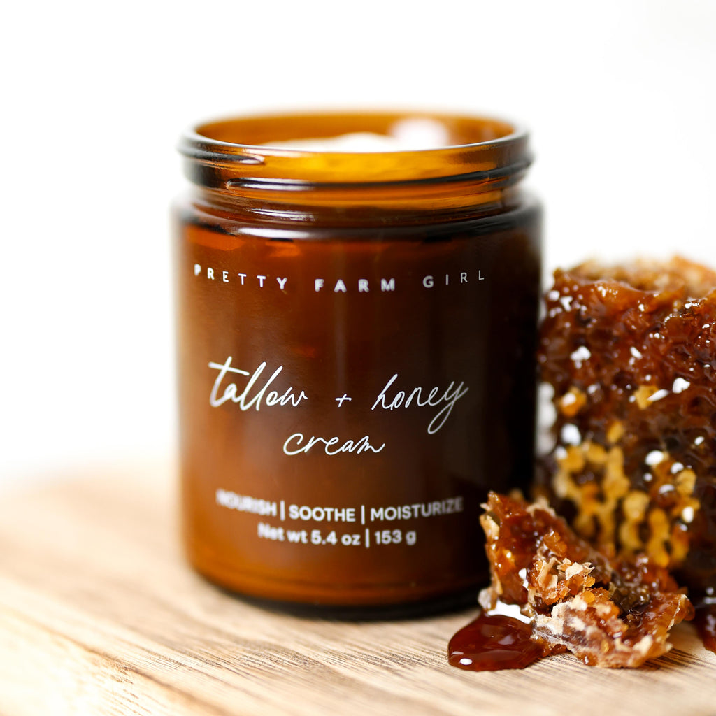 Jar of 'Tallow + Honey Cream' by Pretty Farm Girl with honeycomb and honey on a wooden surface. Fragrance Free Tallow + Honey Cream for Sensitive Skin