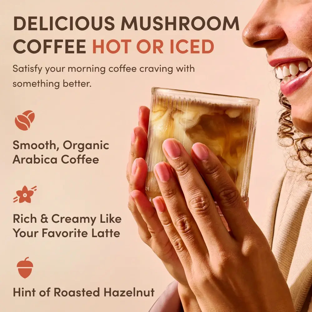 Person enjoying RYZE Superfoods Mushroom Coffee served hot or iced, highlighting smooth organic Arabica coffee with rich, creamy latte flavor and roasted hazelnut notes.