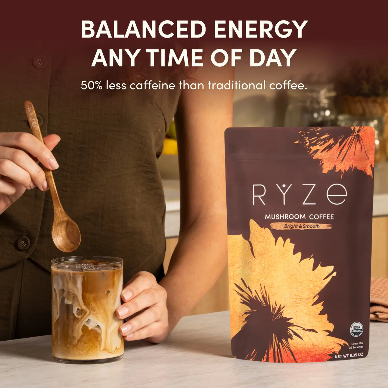 RYZE Superfoods Mushroom Coffee pouch beside a freshly made iced coffee with text highlighting balanced energy and 50% less caffeine than traditional coffee.