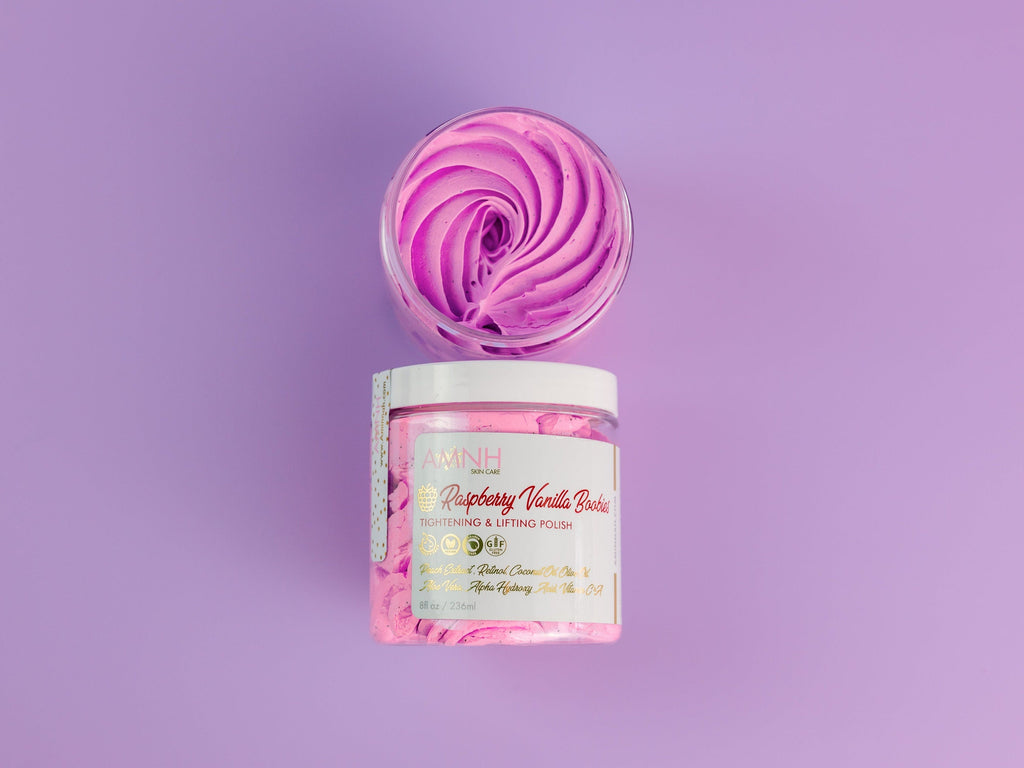 Raspberry Vanilla Boobies Tightening & Lifting Sugar Scrub with whipped raspberry-pink exfoliating polish in a reusable jar, luxury body exfoliant made with natural ingredients to gently smooth, soften and renew skin. Clean beauty, vegan, cruelty-free, paraben-free, gluten-free formula in recyclable packaging from a female-owned brand for radiant, silky-soft skin.