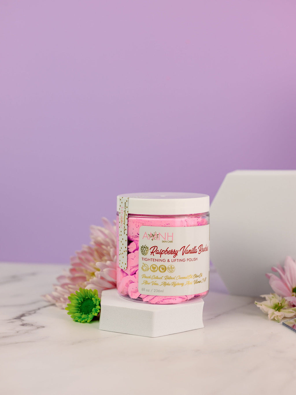 Raspberry Vanilla Boobies Tightening & Lifting Sugar Scrub in a reusable jar with whipped raspberry-pink exfoliating polish, luxury body exfoliant made with natural ingredients to gently exfoliate, smooth, soften, and nourish skin. Clean beauty, vegan, cruelty free, paraben free, gluten free formula with recyclable packaging from a female owned brand for radiant, healthy-looking skin.