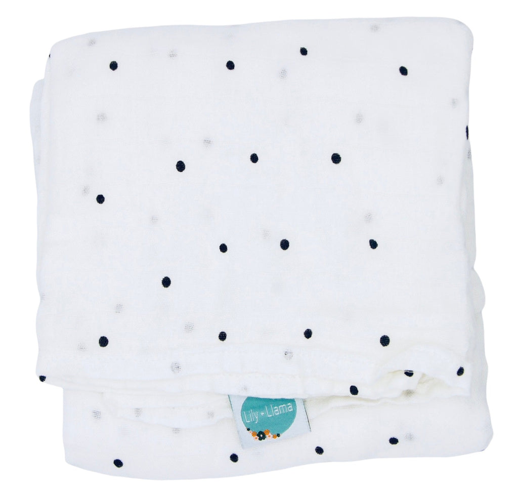 White muslin receiving blanket with classic black polka dots, lightweight breathable baby swaddle blanket featuring a soft Lily + Llama tag, ideal for newborns, infants, and everyday use.