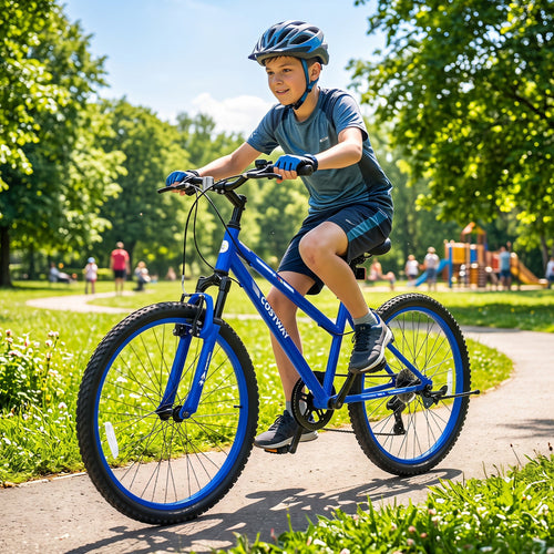 A boy wearing a blue helmet and athletic clothing rides a blue mountain bike on a paved path in a sunny park with green trees and playground equipment in the background.