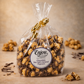 Bag of Enjou Chocolate Sea Salt Caramel Popcorn with a gold ribbon on a brown background Chocolate Sea Salt Caramel Popcorn - Homemade