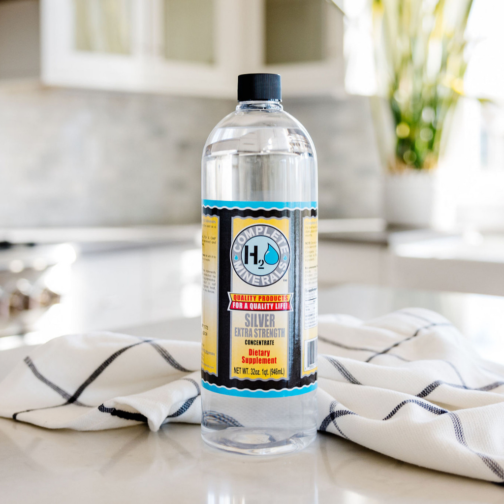 Bottle of hydrogen peroxide on a kitchen counter with a striped towel.