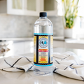 Bottle of hydrogen peroxide on a kitchen counter with a striped towel.
