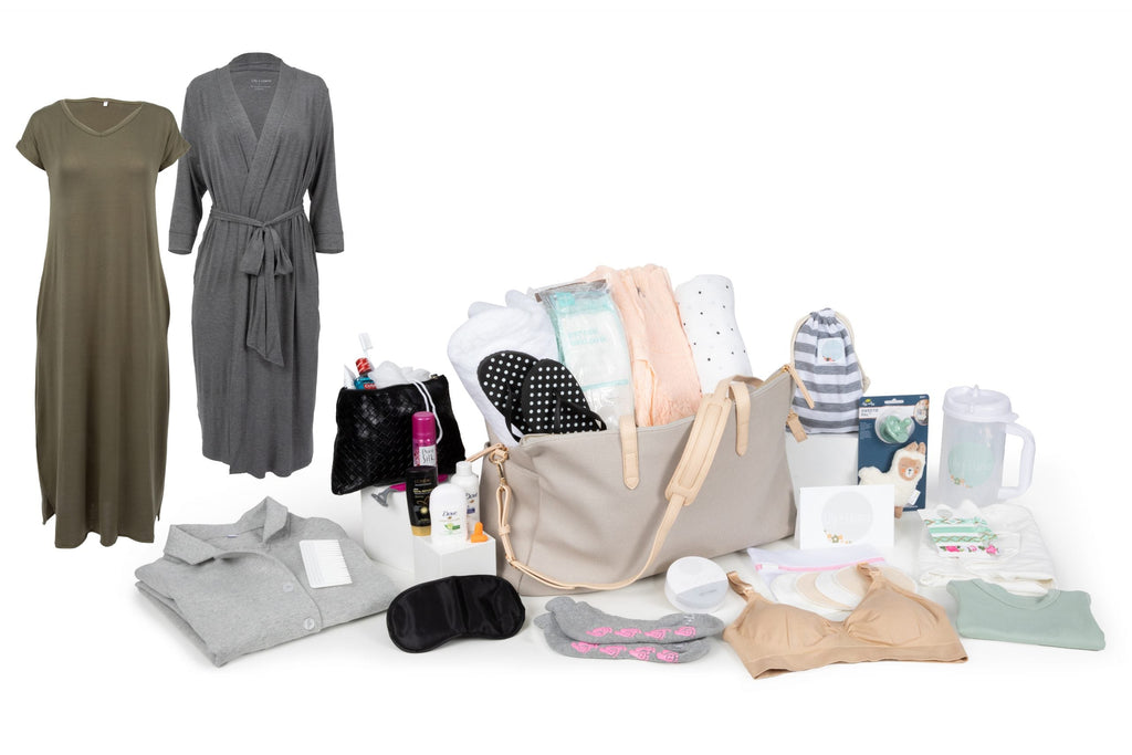 Pre-packed hospital birth bag with maternity essentials including a nursing gown, robe, diaper bag, postpartum supplies, nursing bra, non-slip socks, baby care items, and reusable water cup arranged on a white background.