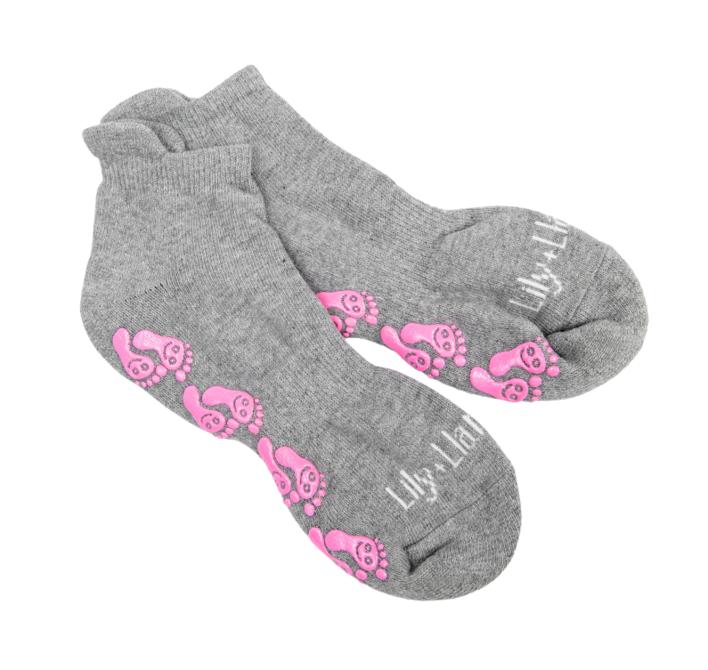 Gray low-cut non-slip hospital socks with pink grip footprints, designed for labor, delivery, postpartum recovery, and enhanced traction on smooth hospital floors.