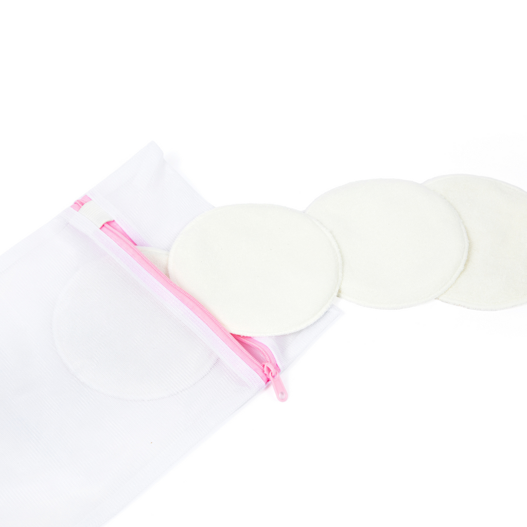 Reusable washable nursing pads with a white mesh zip storage bag featuring a pink zipper, designed for breastfeeding mothers to provide soft, absorbent leak protection.