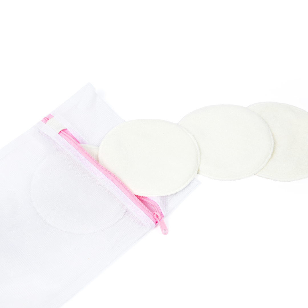 Reusable washable nursing pads with a white mesh zip storage bag featuring a pink zipper, designed for breastfeeding mothers to provide soft, absorbent leak protection.
