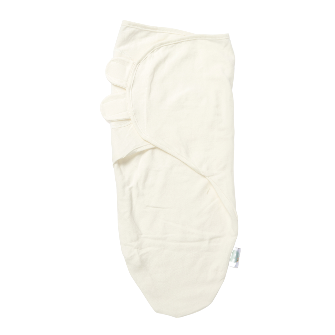 Cream-colored baby swaddle with secure hook-and-loop closure, soft wrap design, and cozy newborn sleep sack on a white background.