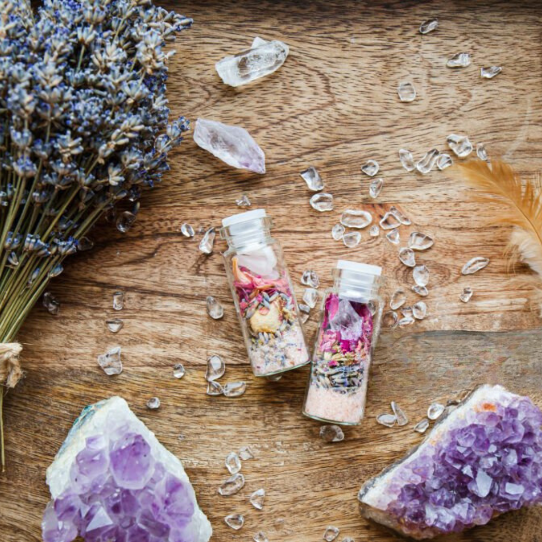 Custom affirmation spell jars with crystals, dried flowers, lavender, healing herbs, amethyst gemstones, intention jars, handmade spiritual gifts, manifestation tools, witchcraft altar supplies, ritual jars on rustic wooden background